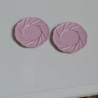1:12 scale miniature metal dining plates with swirl rim in pink, medium, set of 2, shown from above on a gray surface