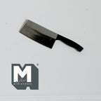 1:12 scale miniature metal cleaver knife in silver with a dark handle and wide rectangular blade, on a white surface