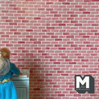 1:12 scale miniature red brick wall style wallpaper, running bond brick pattern, shown as a wall behind a doll