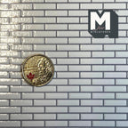 1:12 scale miniature embossed white subway tile wallpaper with gray grout, glossy brick layout, shown with a coin