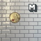1:12 scale miniature embossed white subway tile wallpaper with gray grout, larger glossy tiles, shown with a coin