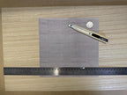 1:12 scale miniature embossed concrete panel wall sheet in gray, square sheet shown with a ruler and craft knife
