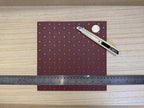 1:12 scale miniature embossed brocade wallpaper with fleur de lis in burgundy with gold accents, shown with a ruler
