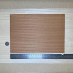 1:12 scale miniature sapele peel and stick wood veneer sheet in reddish brown with ribbon grain, shown with a ruler
