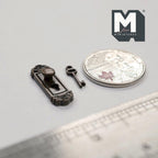 1:12 scale miniature door knob plate with keyhole and key in antique bronze, shown beside a coin and a ruler