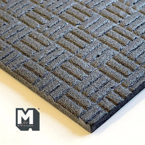 1:12 scale miniature basketweave brick flooring foam board in gray, close corner view of the embossed pattern