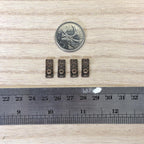 1:12 scale miniature knobs with embossed rectangular backplates in antique copper, set of 4, with a coin and ruler