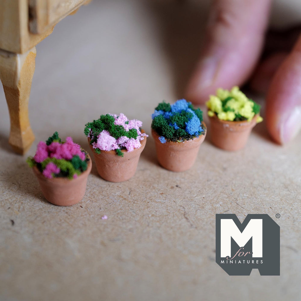 1:12 scale miniature small terracotta pots filled with soil and dark pink, light pink, blue and yellow flowers