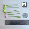 1:12 scale miniature pink calla lily flower stems with orange centers and lime green leaves with white speckles, on green wrapped stems