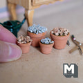 1:12 scale miniature terracotta clay pots, two large and two small, filled with dark soil and topped with blue grey gravel and tan stones