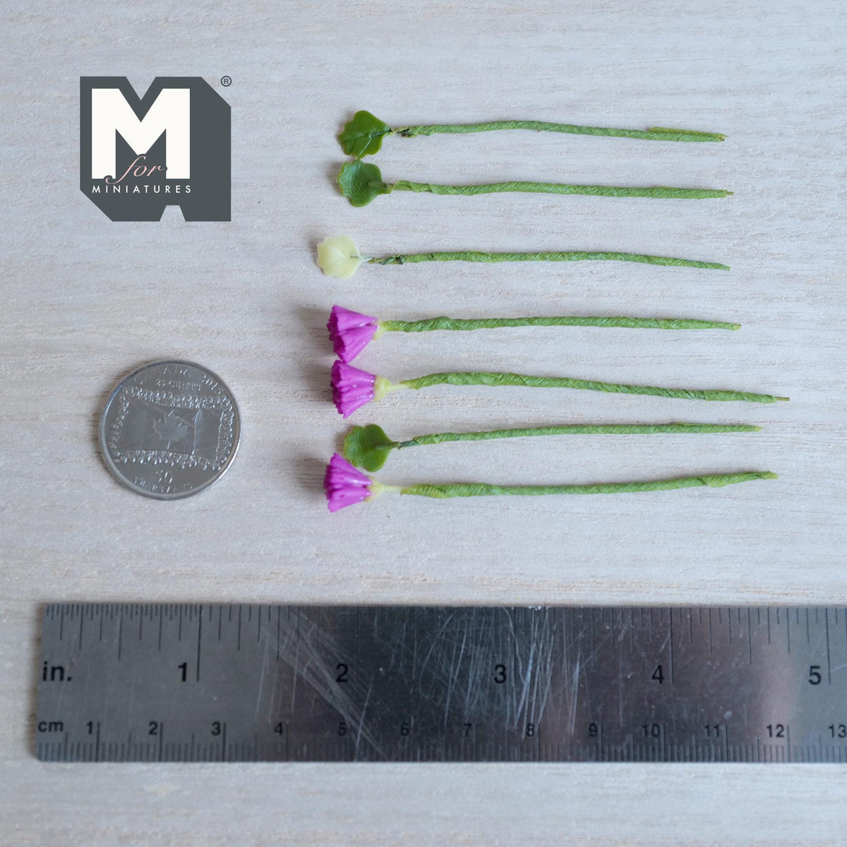 1:12 scale miniature purple carnation flower stems with a pale green bud and leaf stems, on green wrapped stems
