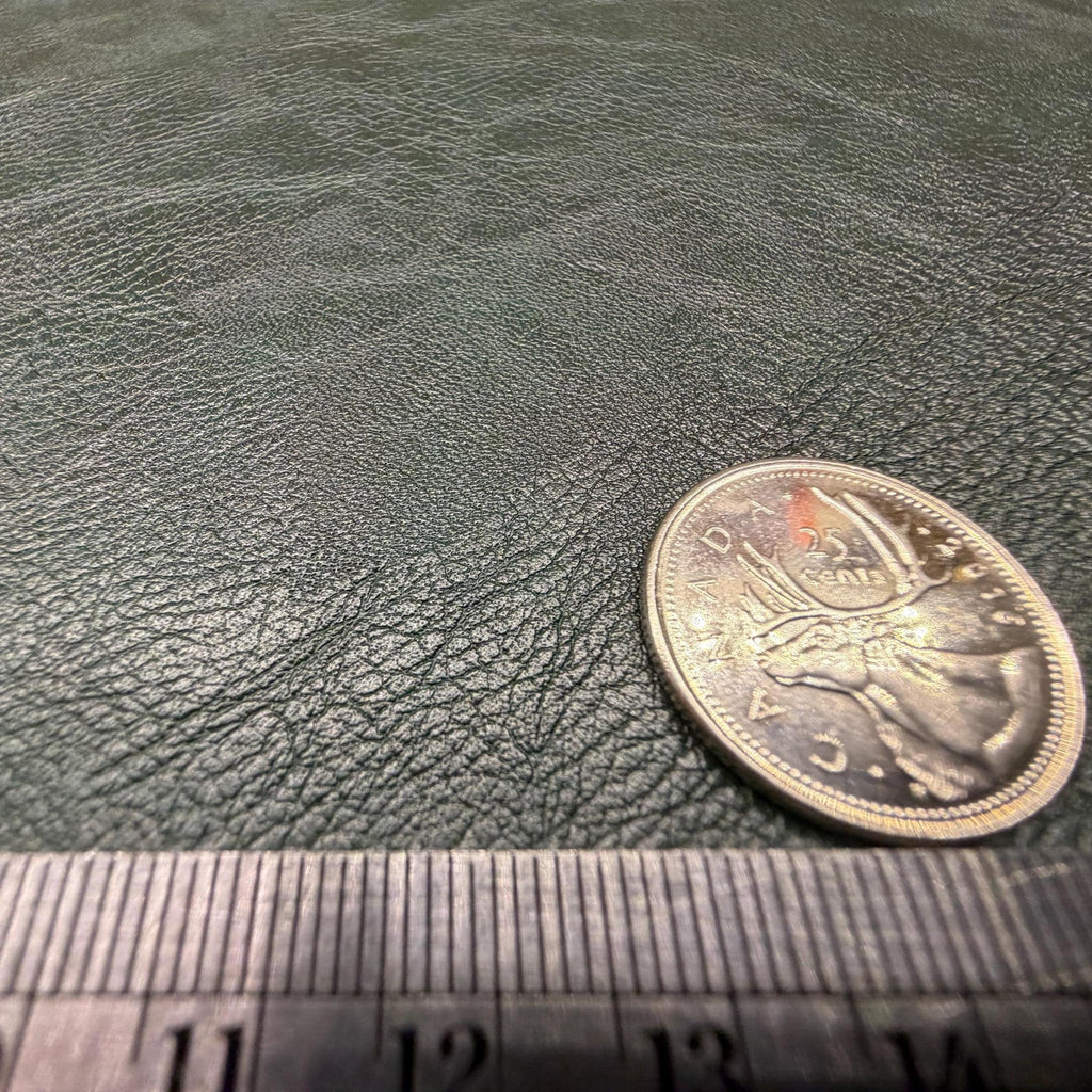 Close view of the pebbled grain on the dark green faux leather sheet