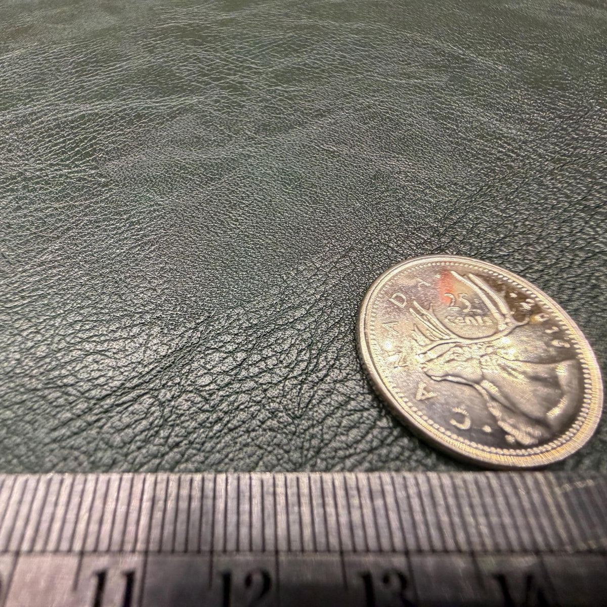 Close view of the pebbled grain on the dark green faux leather sheet