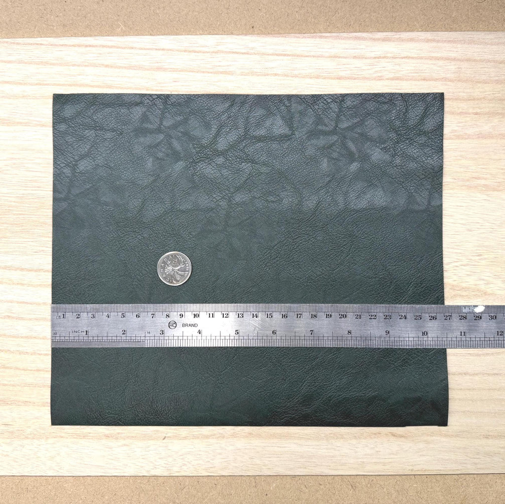 Dark green faux leather sheet with soft pebbled grain and a low-sheen matte surface, 10-7/16 x 8-7/8 inch