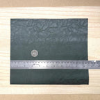 Dark green faux leather sheet with soft pebbled grain and a low-sheen matte surface, 10-7/16 x 8-7/8 inch