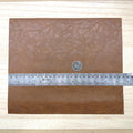 Brown faux leather sheet with soft pebbled grain and a low-sheen matte surface, 10-7/16 x 8-7/8 inch