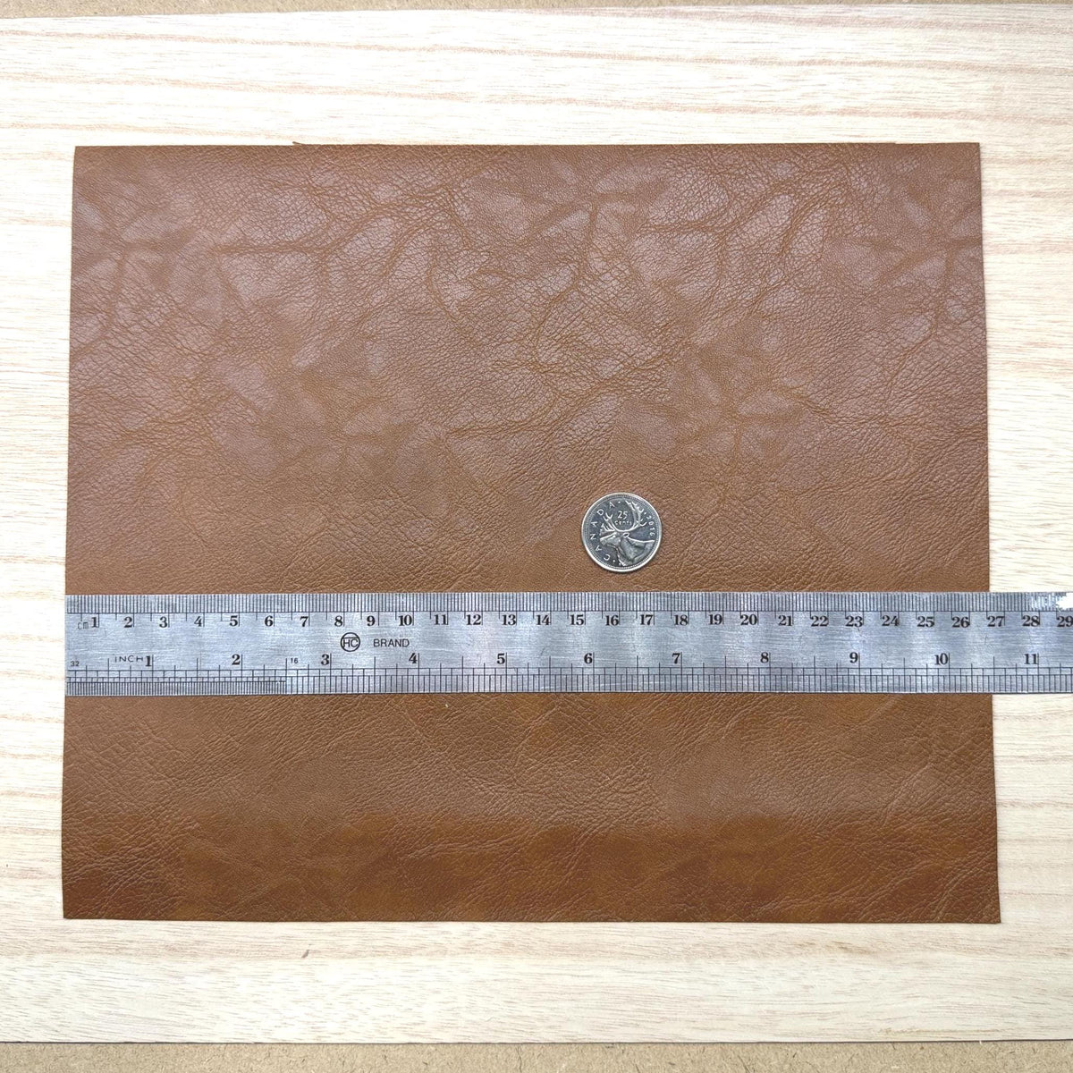 Brown faux leather sheet with soft pebbled grain and a low-sheen matte surface, 10-7/16 x 8-7/8 inch