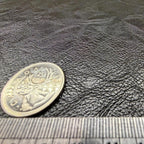 Close view of the pebbled grain on the black faux leather sheet