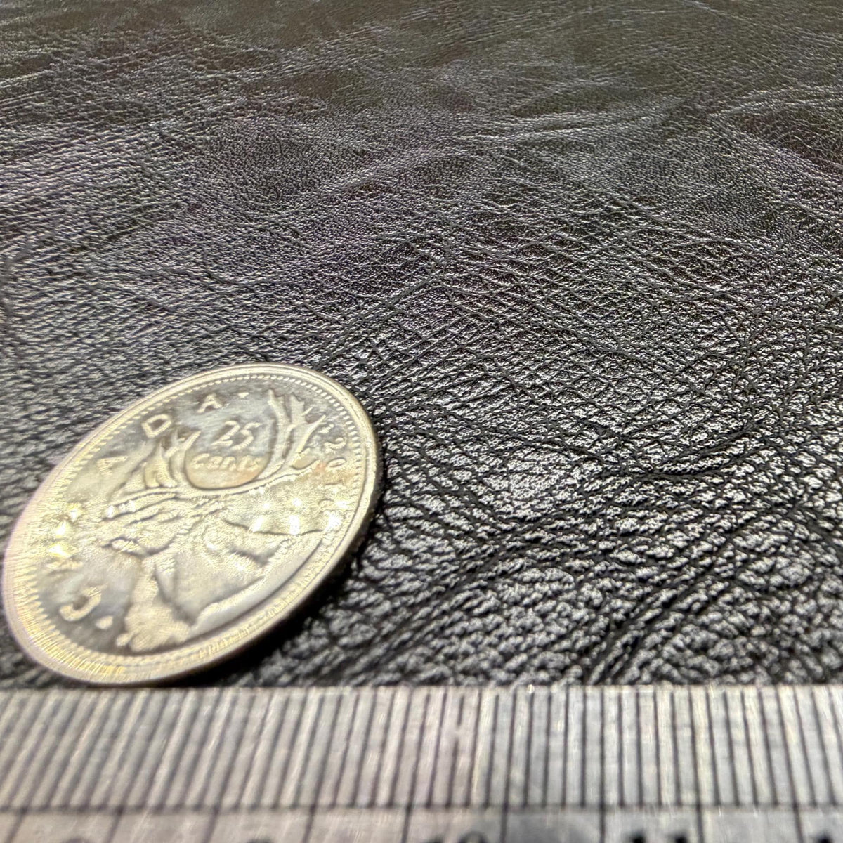 Close view of the pebbled grain on the black faux leather sheet
