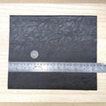 Black faux leather sheet with soft pebbled grain and a low-sheen matte surface, 10-7/16 x 8-7/8 inch