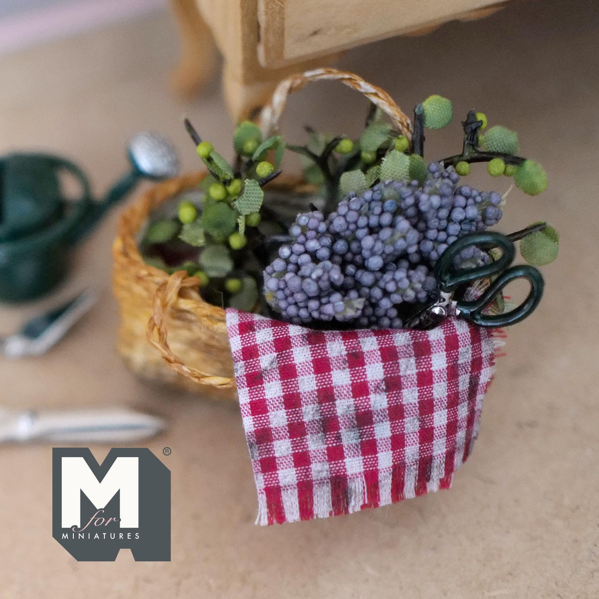 Close view of the grapes and gingham cloth in the miniature harvest basket