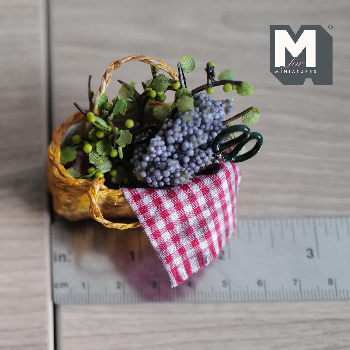 Miniature grape harvest basket shown next to a ruler marked in inches and centimetres for scale