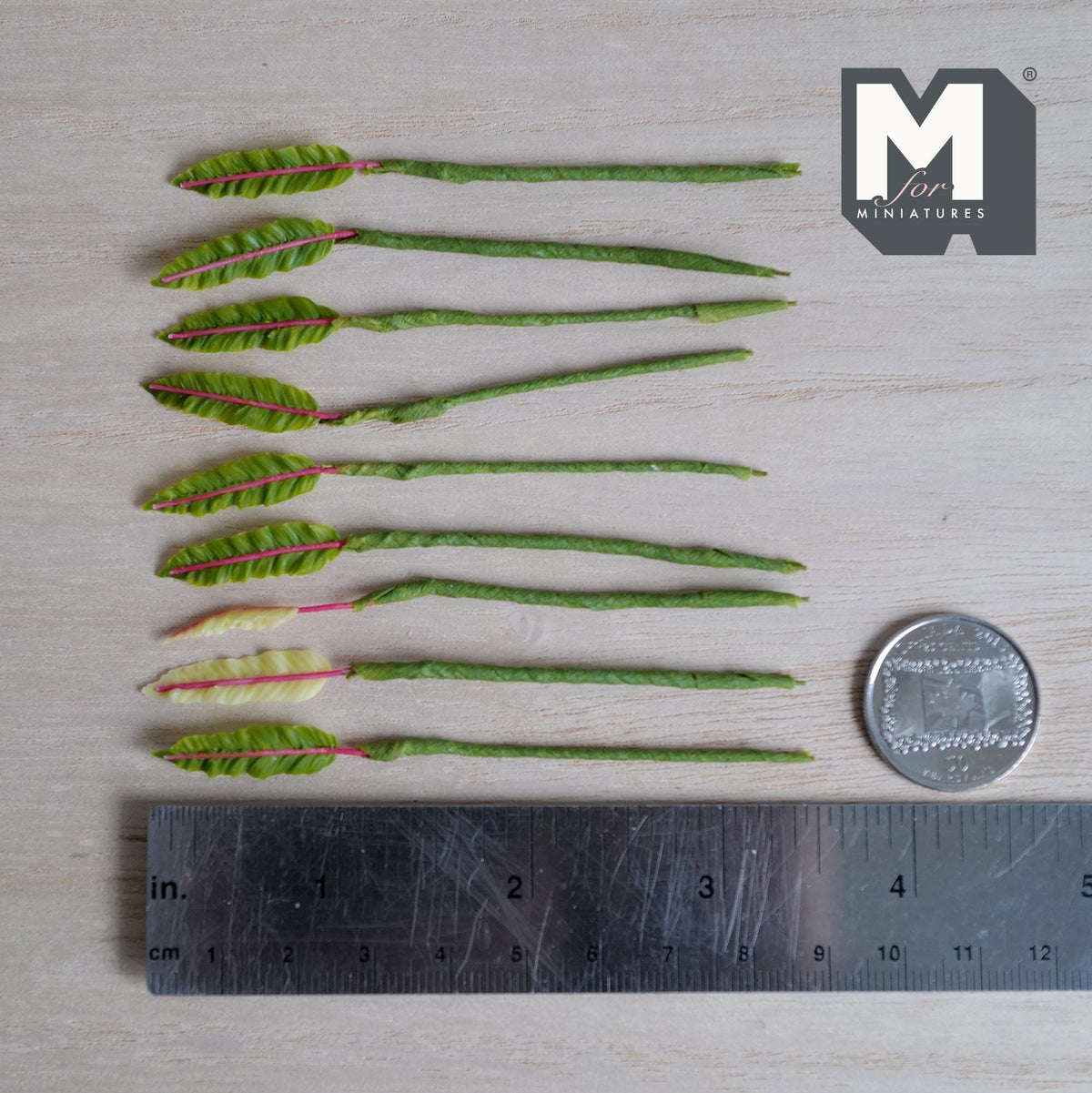 1:12 scale miniature leaf plant stems with long narrow ridged leaves and bright pink center veins, seven green and two pale cream