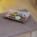 1:12 Scale Miniature Iced Donuts on Rustic Aged Metal Baking Tray with Parchment, Set of 9, 1-5/8 inch long, Dollhouse Decor