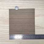 Miniature walnut wood veneer sheet in medium greyish brown with straight grain and fine darker pore lines, 5-7/8 inch square