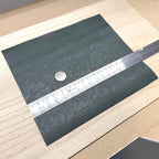 Dark green faux leather sheet for 1:12 scale miniature upholstery and book covers
