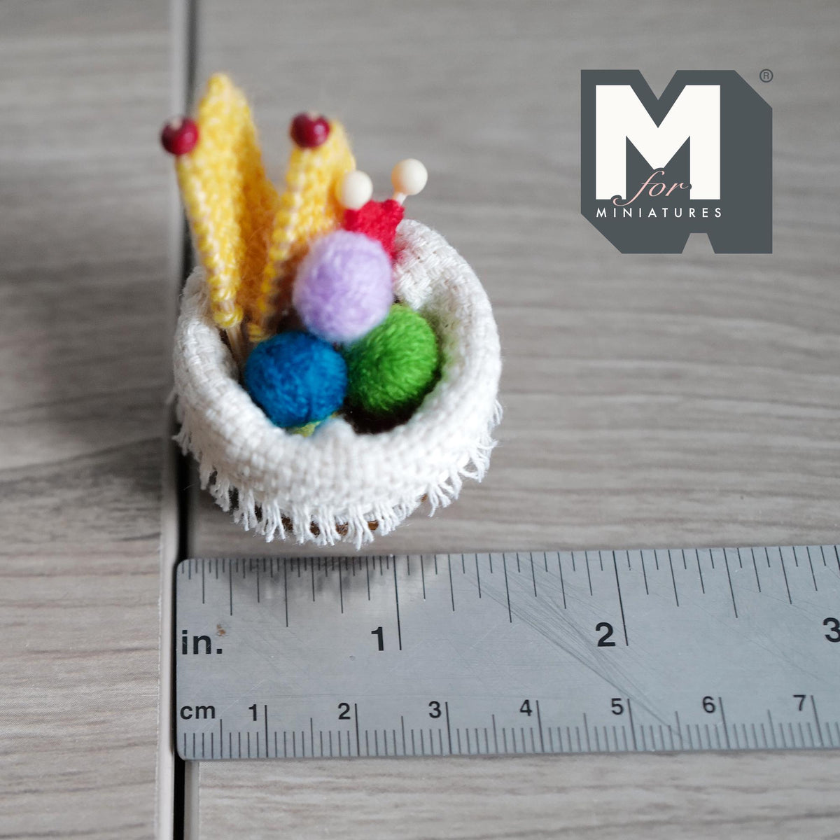 Miniature knitting basket set shown next to a ruler marked in inches and centimetres for scale