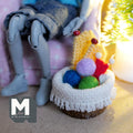Miniature knitting basket set shown beside a seated 1:12 scale doll for size
