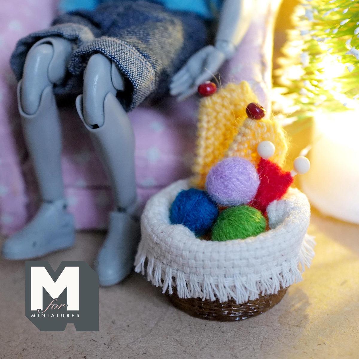 Miniature knitting basket set shown beside a seated 1:12 scale doll for size