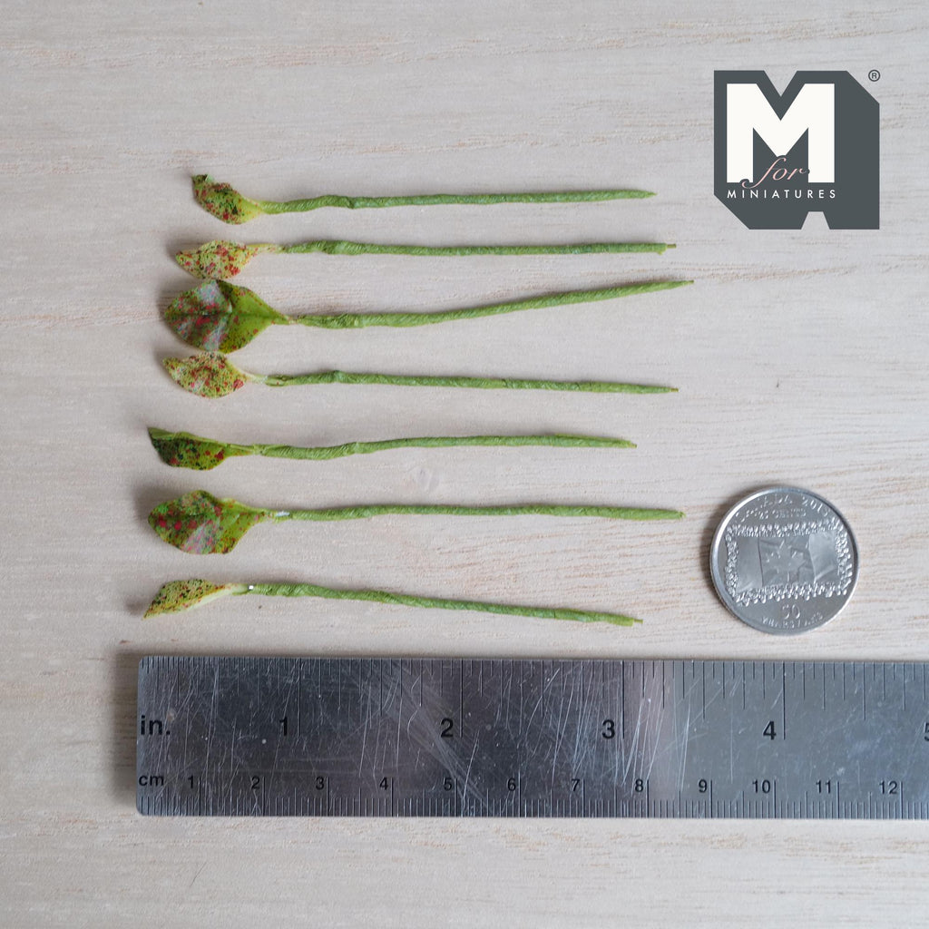 1:12 scale miniature plant stems with small pointed lime green leaves covered in red and pink speckles