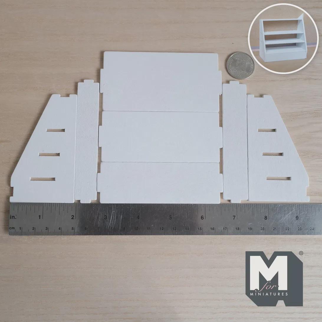 Unassembled 1:12 scale miniature 4 tier stepped display shelf kit in white wood, laid flat beside a ruler and coin, with an inset of the assembled shelf