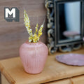 1:12 scale miniature weathered pink clay plum shaped vase with soft grooves, holding pale dried grass stems