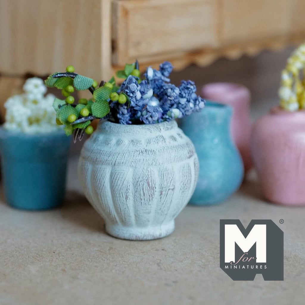 1:12 scale miniature weathered gray clay urn pot with fluted sides, planted with blue flowers and green leaves